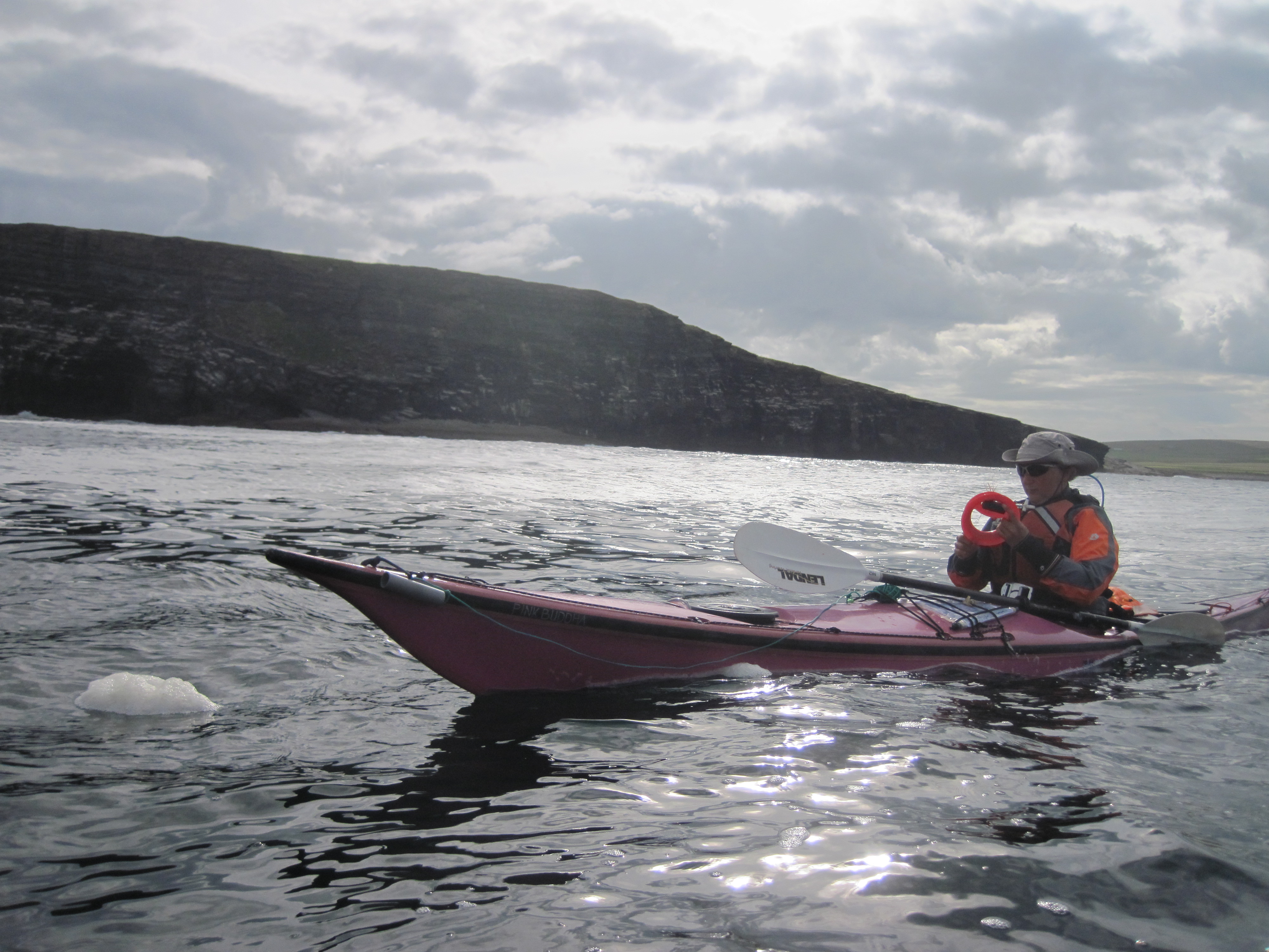 Charlotte Gannet fishing with a hand spool in her kayak.